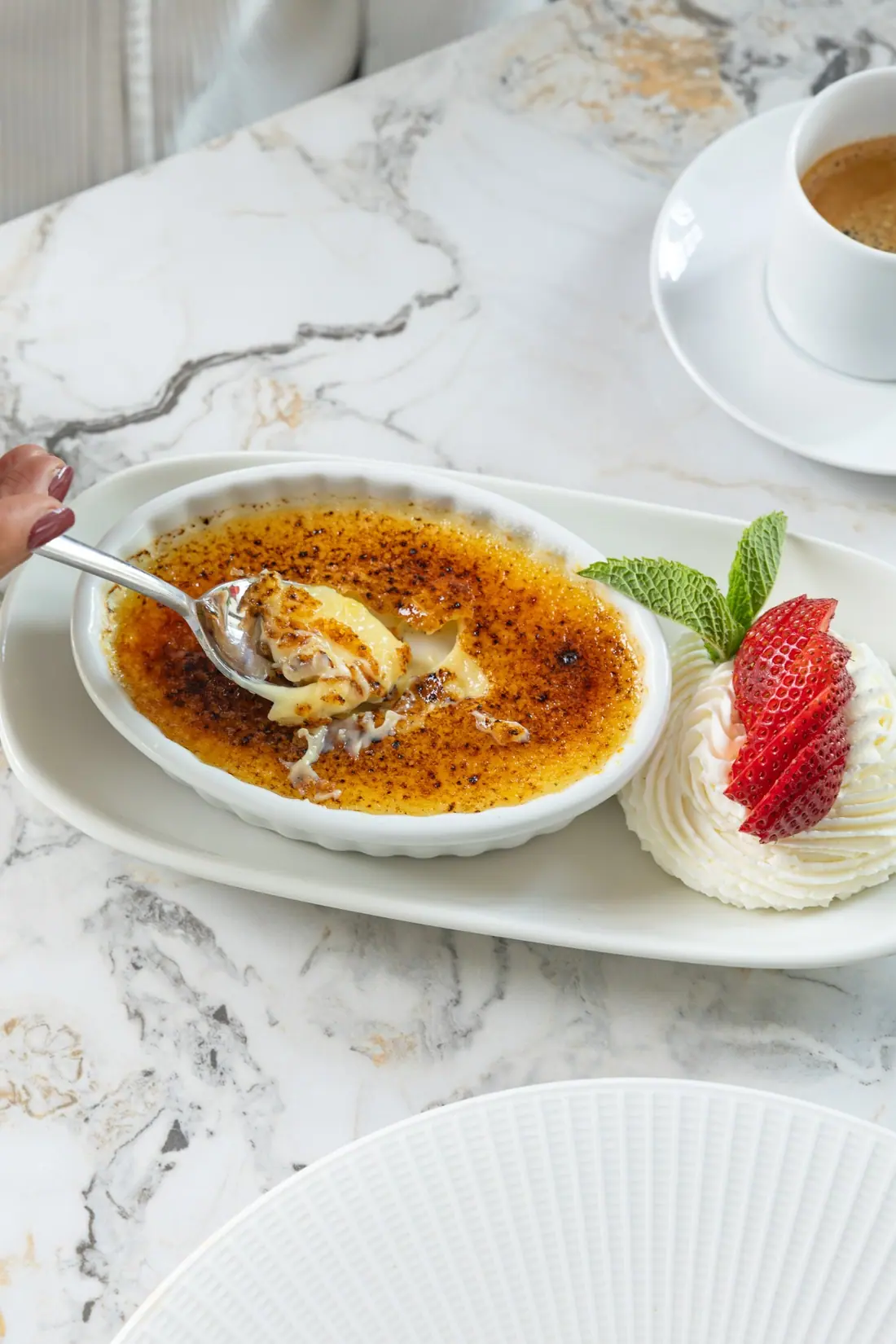 Crème brûlée and coffee on marble