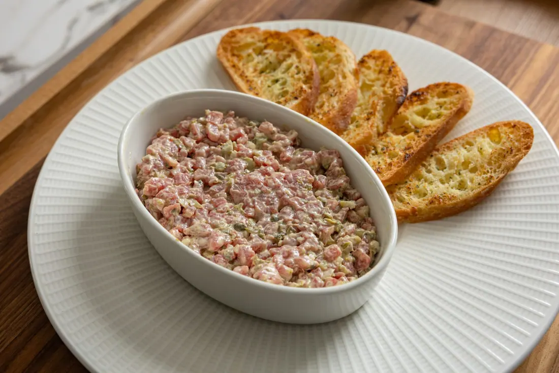 Steak tartare being mixed in a bowl